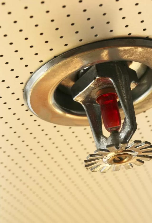 close up of sprinkler system in ceiling
