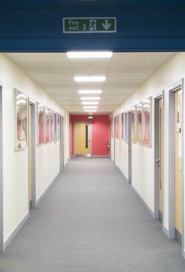 Modern secondary school corridor with open fire doors